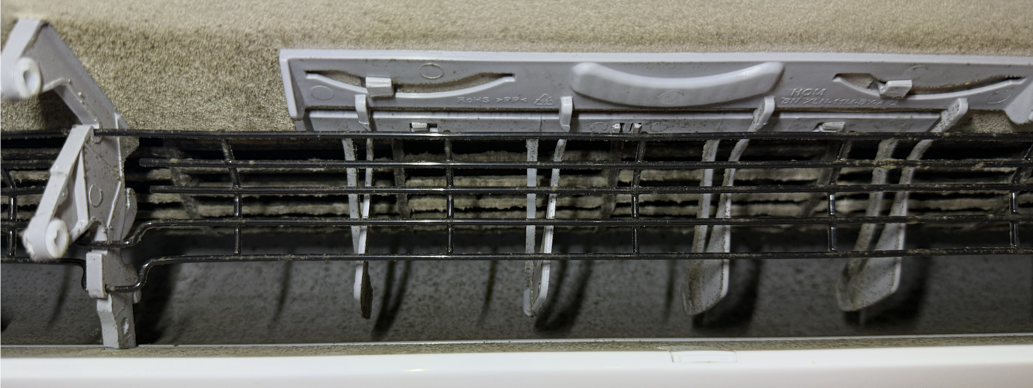Mini-split coil and blower caked with dust and mold before cleaning